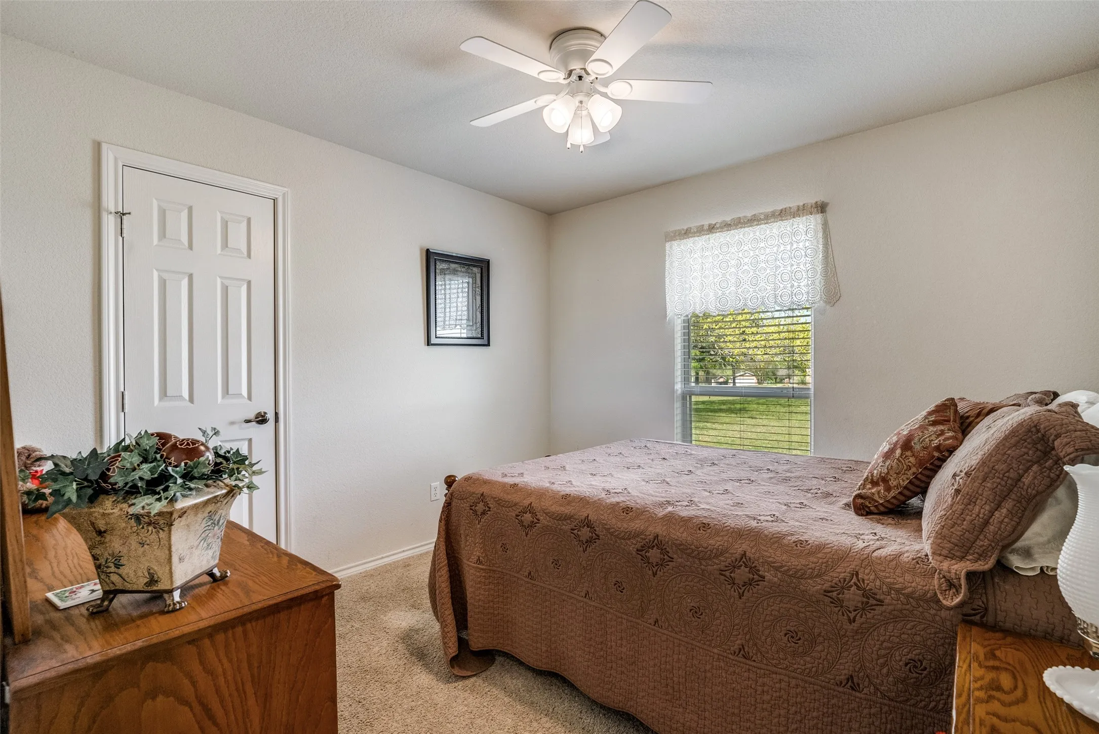 Bedroom featuring light carpet and ceiling fan