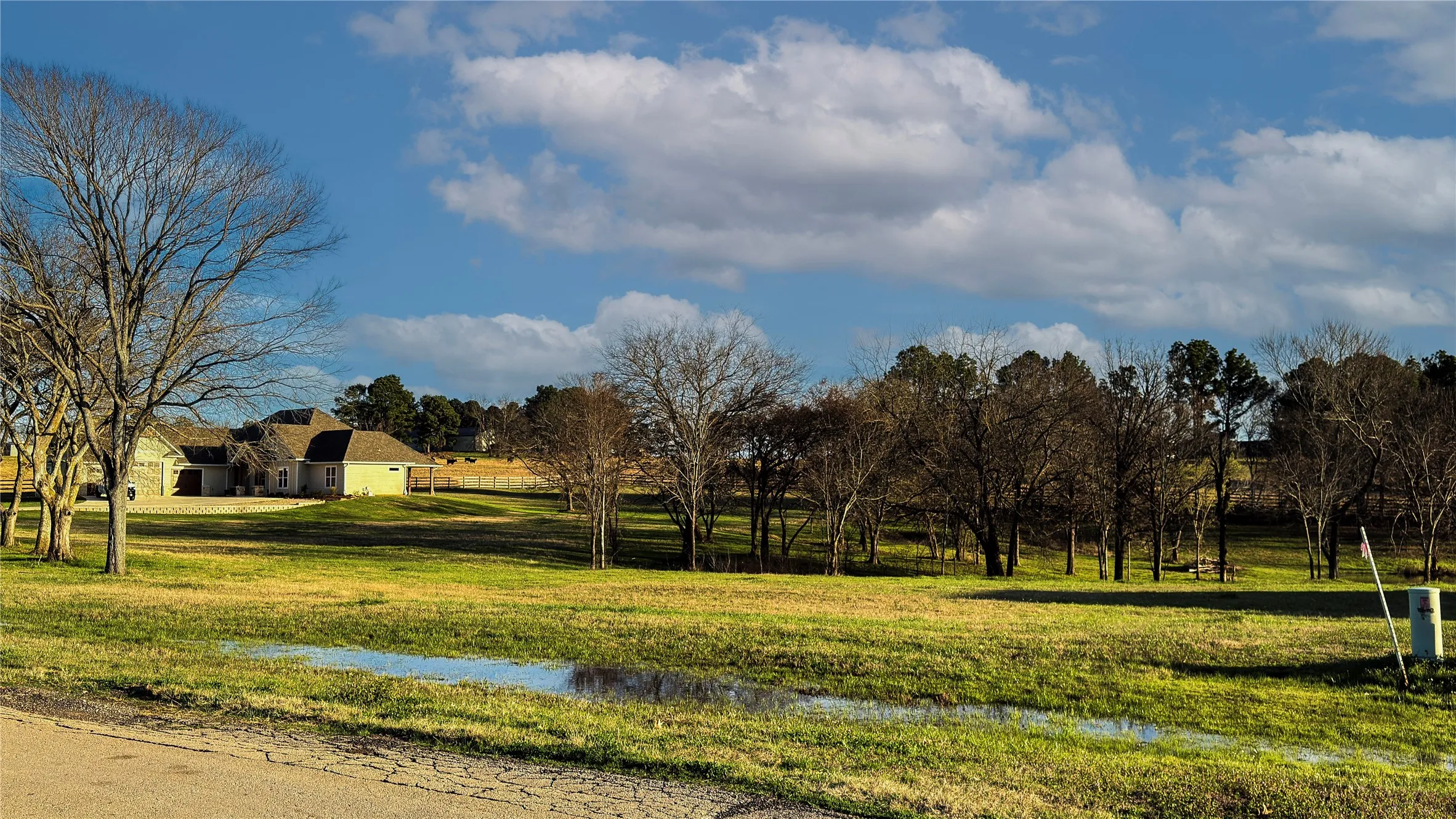 View of community featuring a water view and a lawn