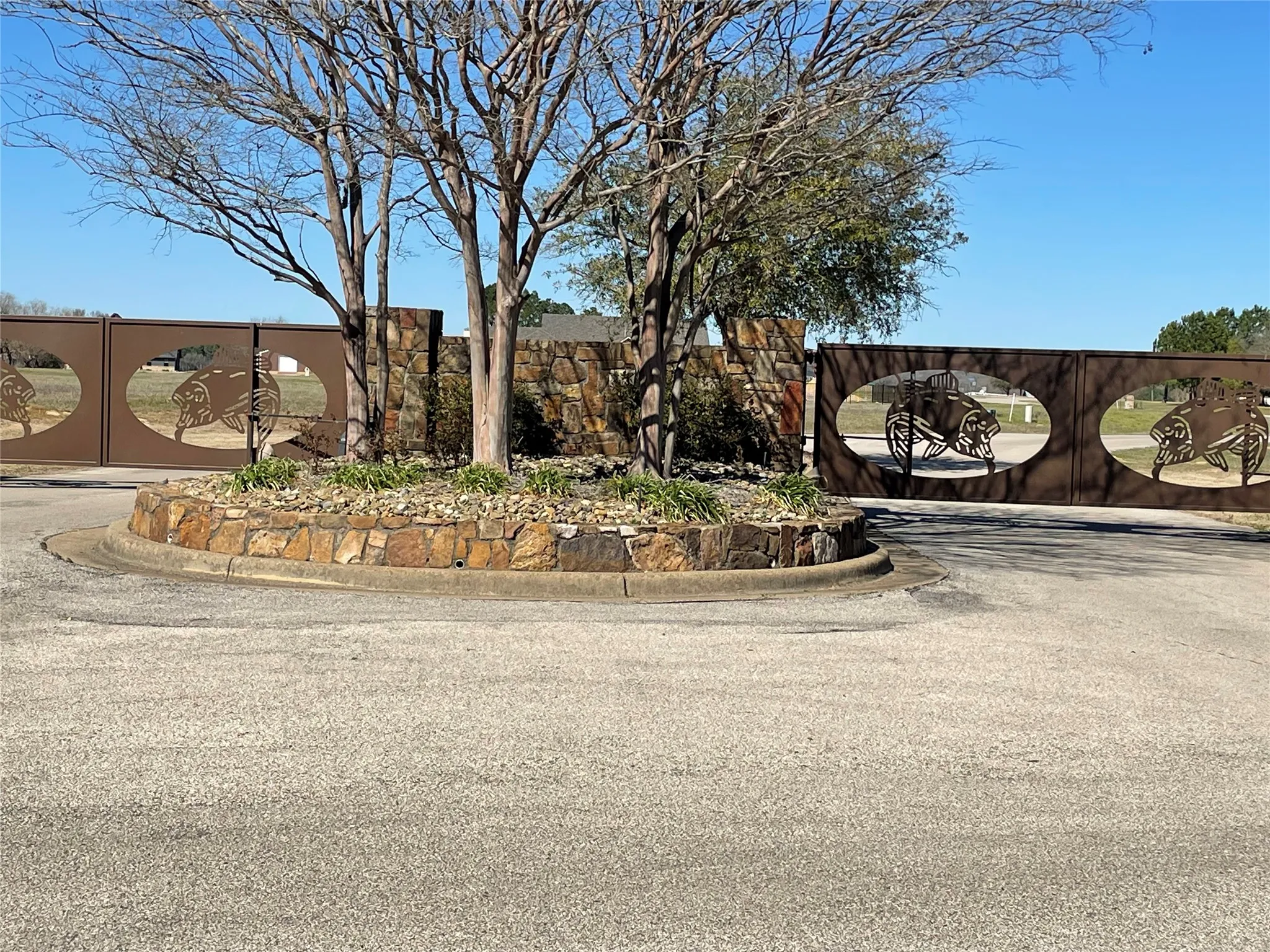 View of street with curbs and a gate