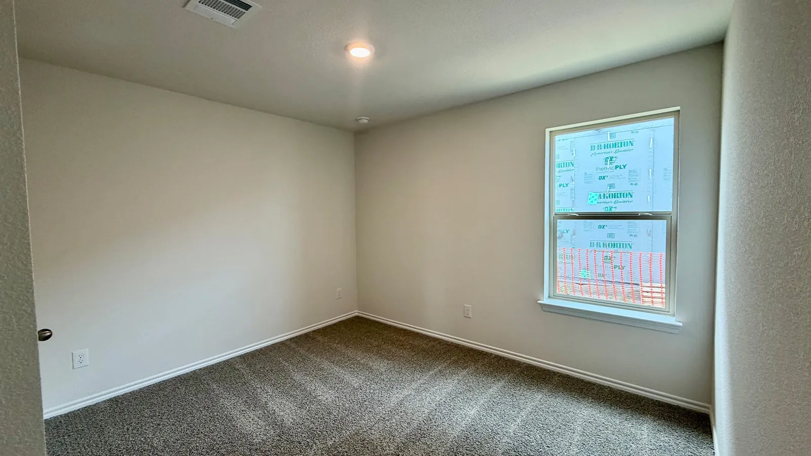 Neutral wall paint with textured carpet flooring