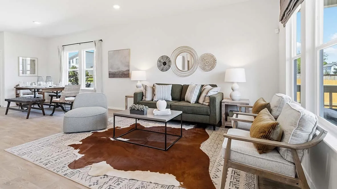 Open-concept living space featuring wood-finish flooring, recessed lighting, and large windows