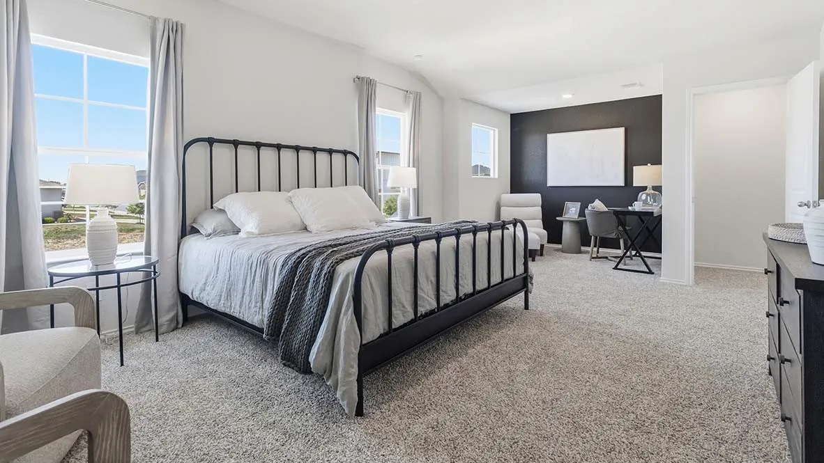 Spacious room featuring carpeting, multiple windows, a recessed ceiling, and a distinct accent wall