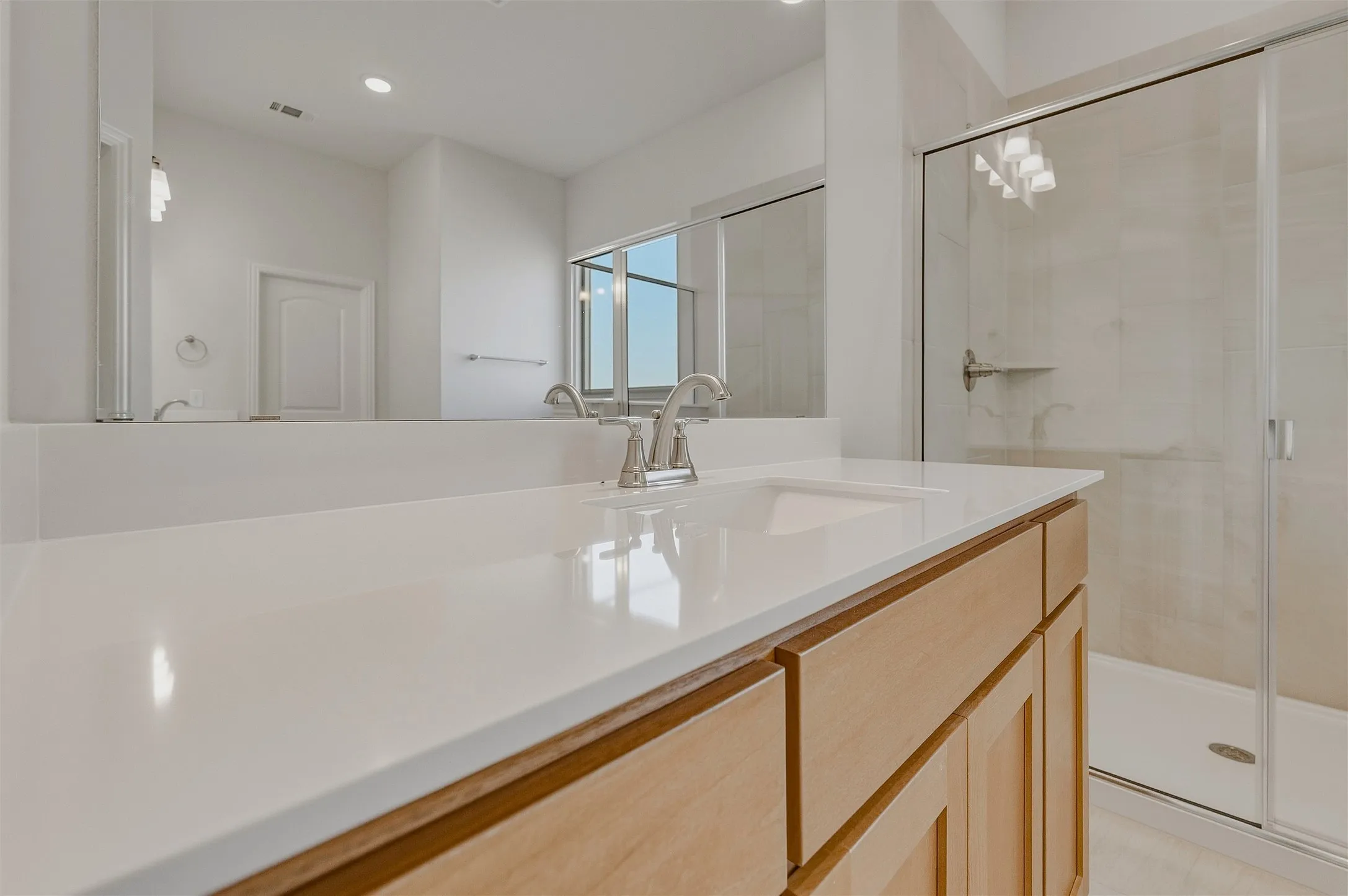 Dual-tone vanity with an integrated sink and brushed nickel faucet
