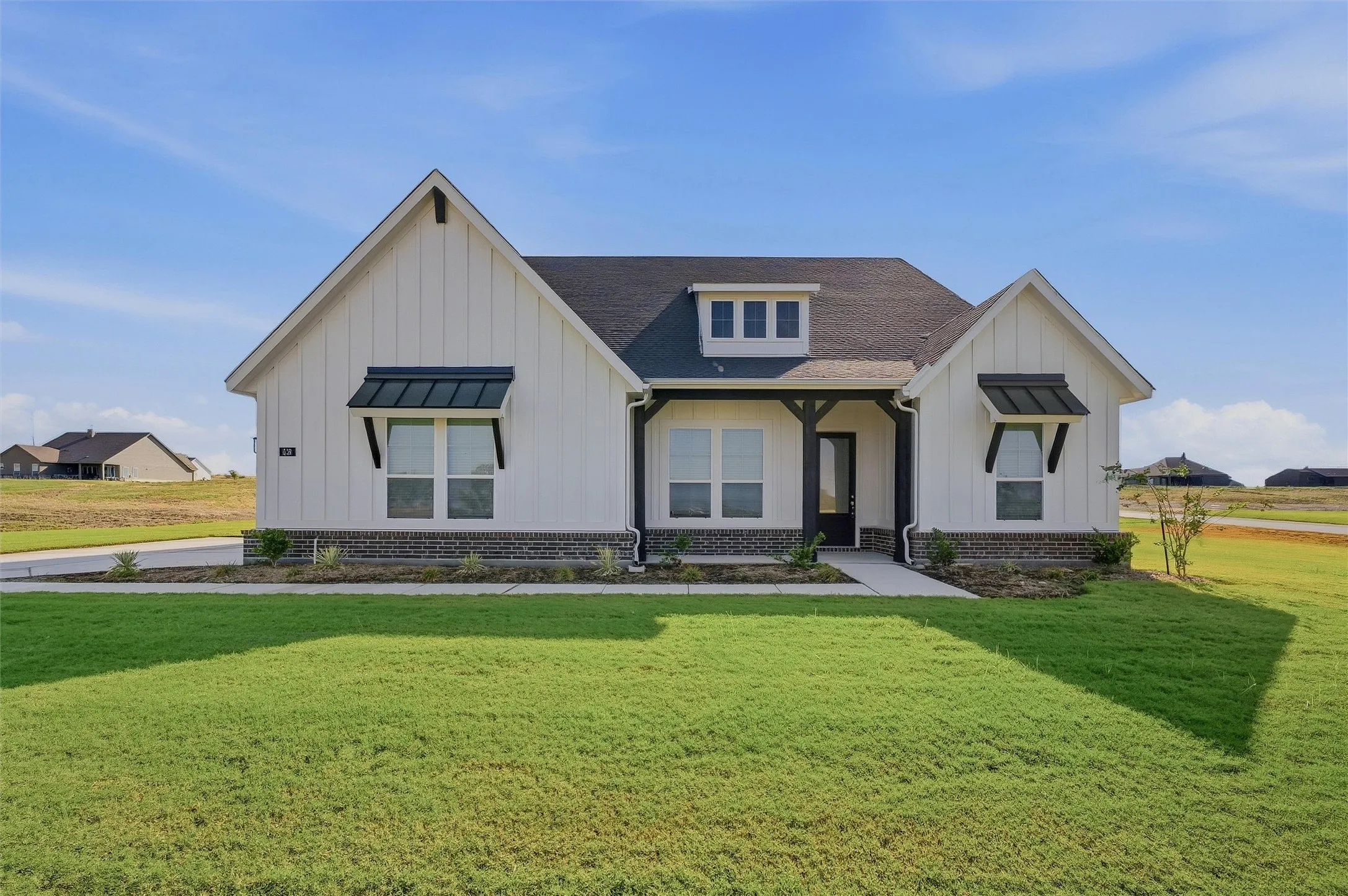 Board-and-batten siding with a stone veneer foundation