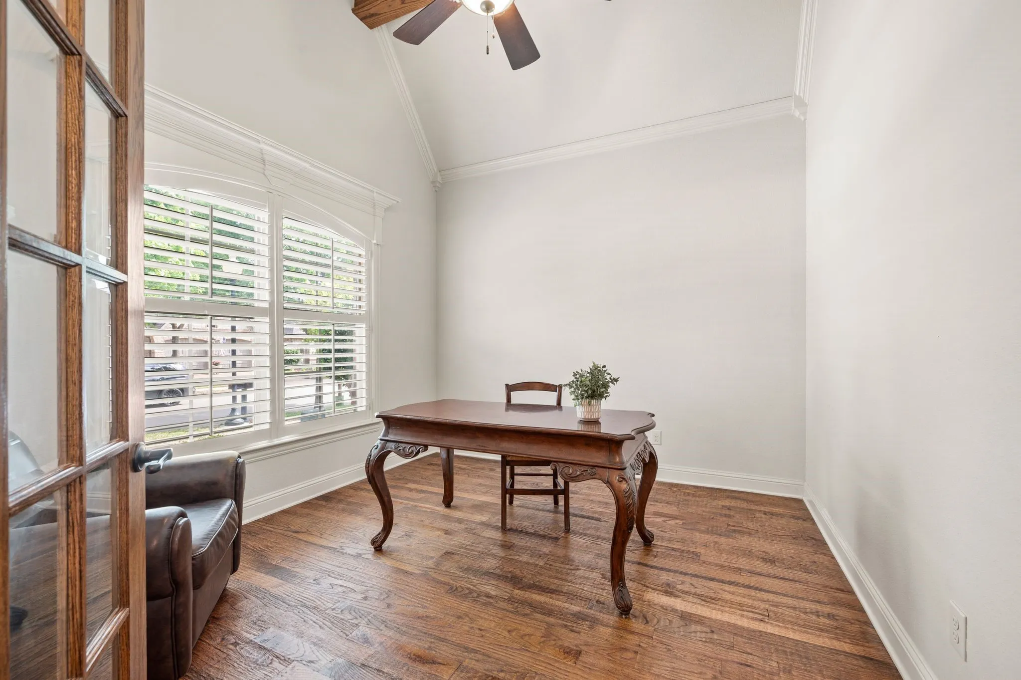 Designated office with plantation shutters, and vaulted ceiling—