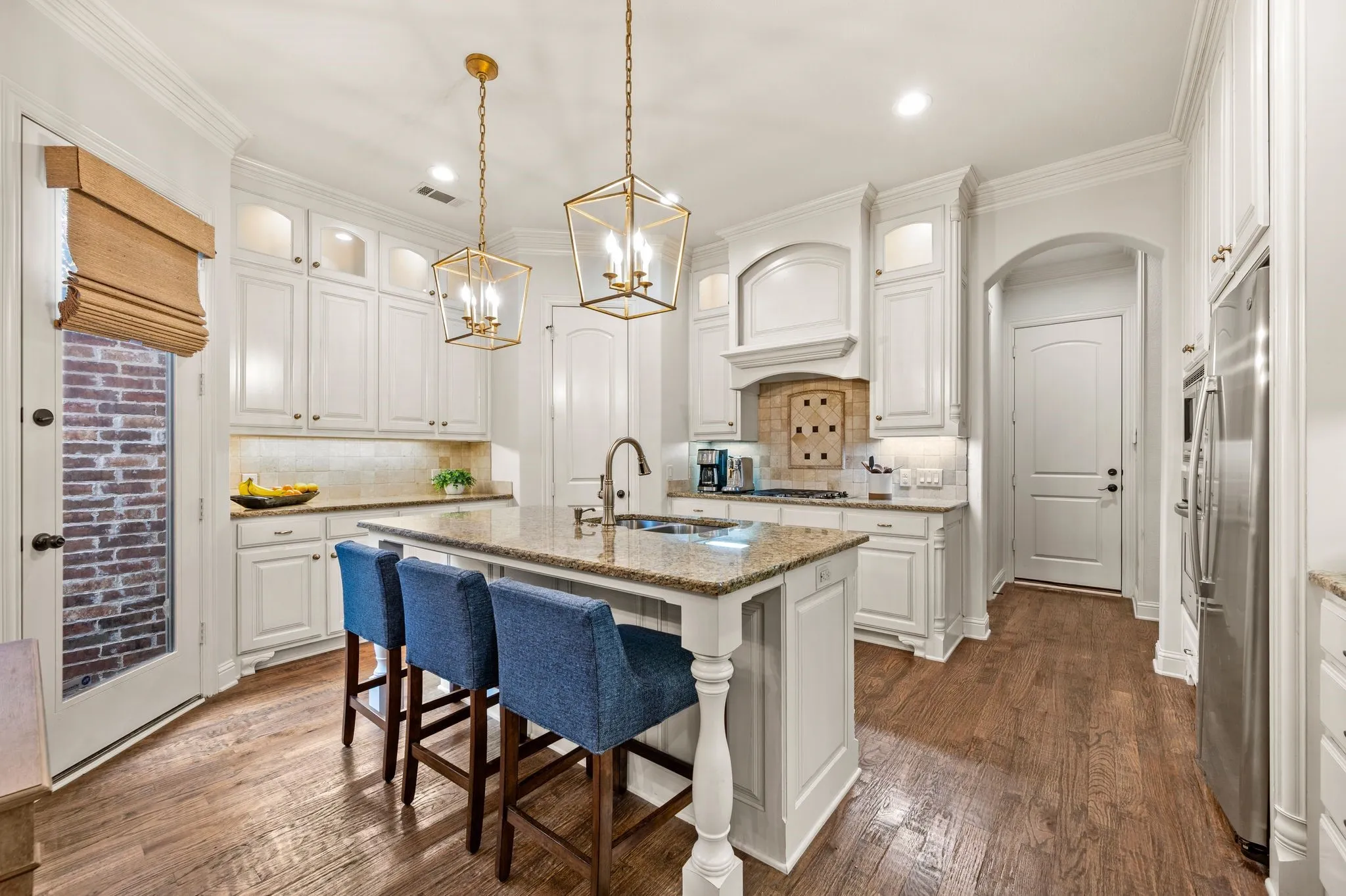 Kitchen featuring stainless steel appliances, gas cooktop, and custom cabinetry.