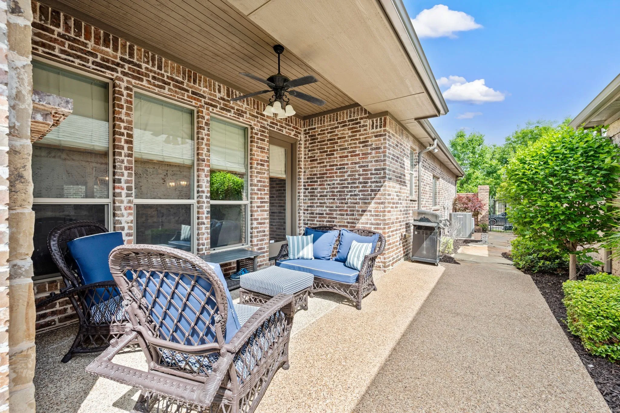 Extended covered patio with outdoor fireplace and ample room for relaxing or hosting