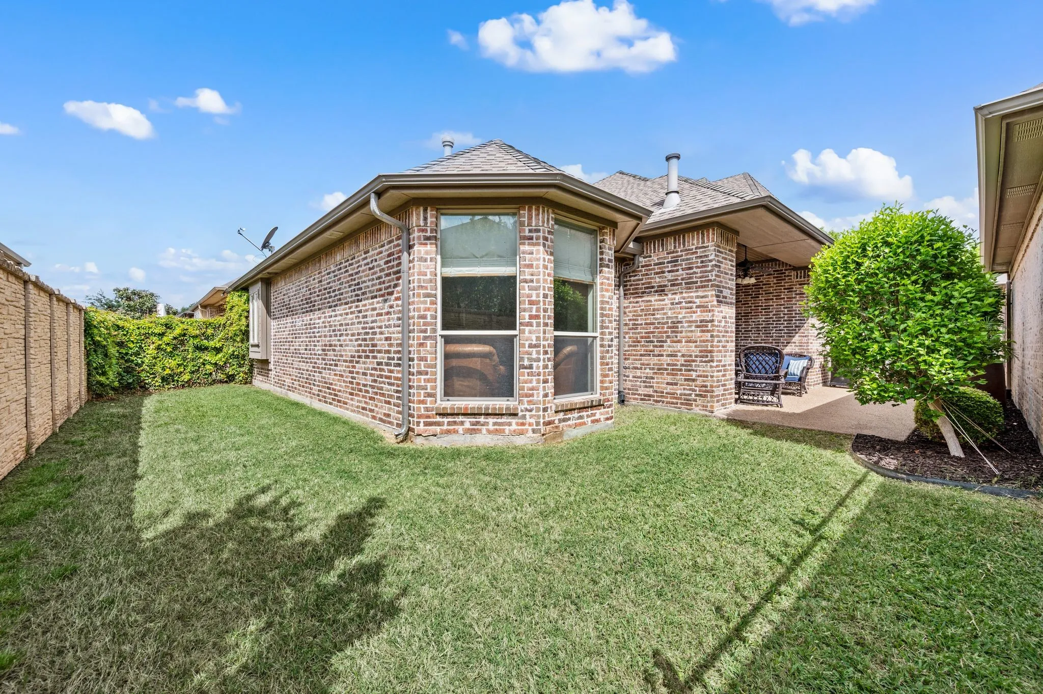 Private backyard with maintained lawn and access to covered outdoor living area