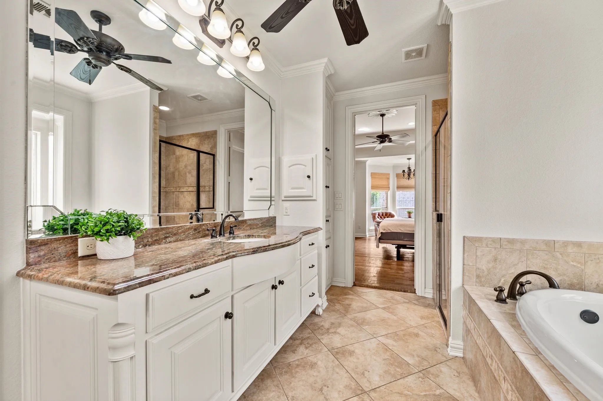 Alternate view of primary bath showcasing large walk-in shower, a jetted tub, and extended vanity space