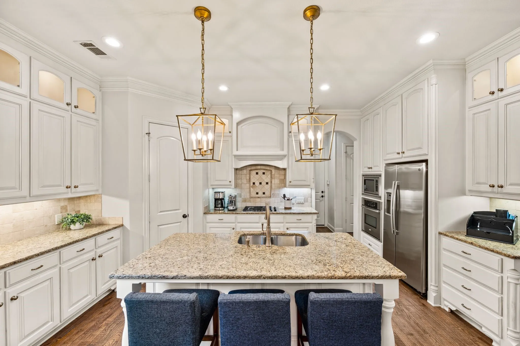 Gourmet kitchen with large island, granite countertops, and ample cabinetry.
