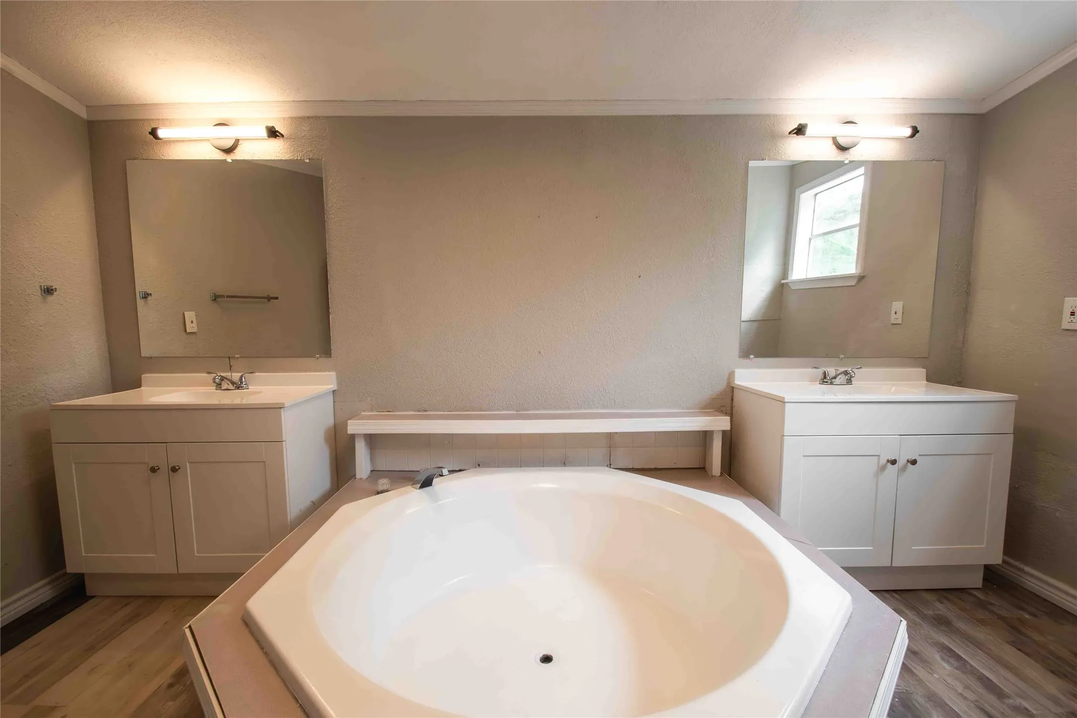 View of large tub and dual sinks