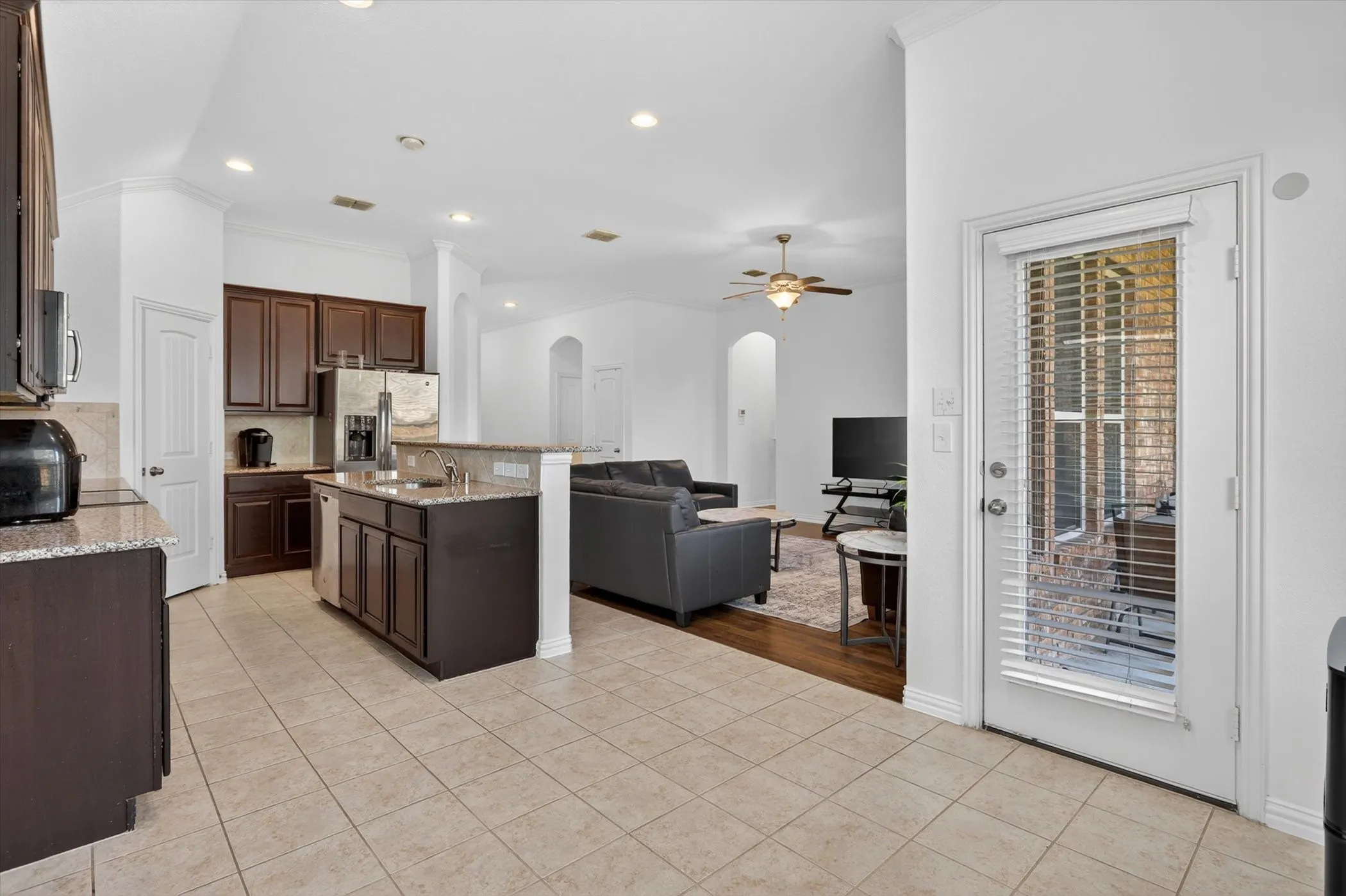 Kitchen featuring granite countertops, wood-finish cabinetry, and stainless steel appliances