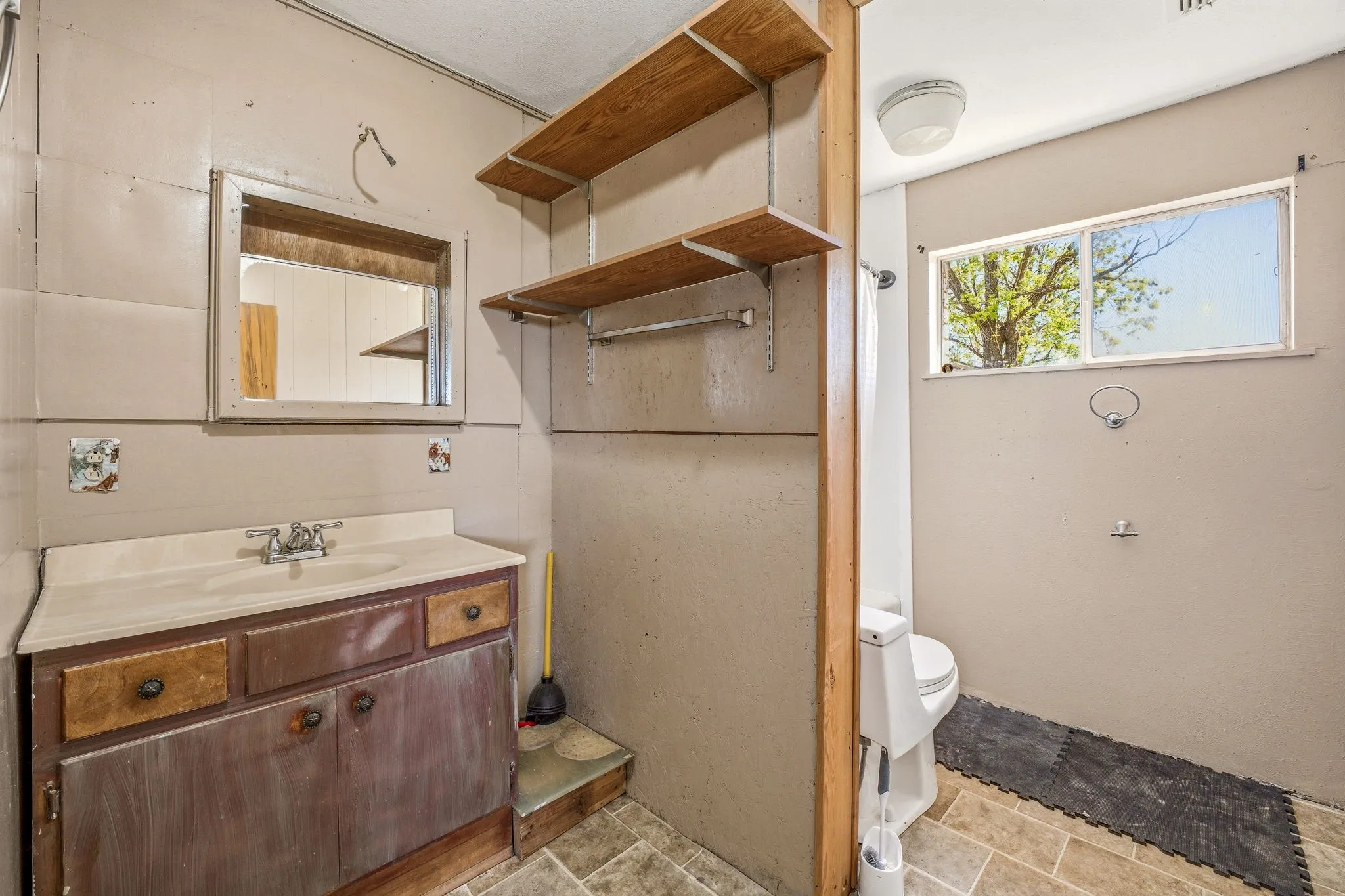 Full bathroom featuring vanity and stone finish floors