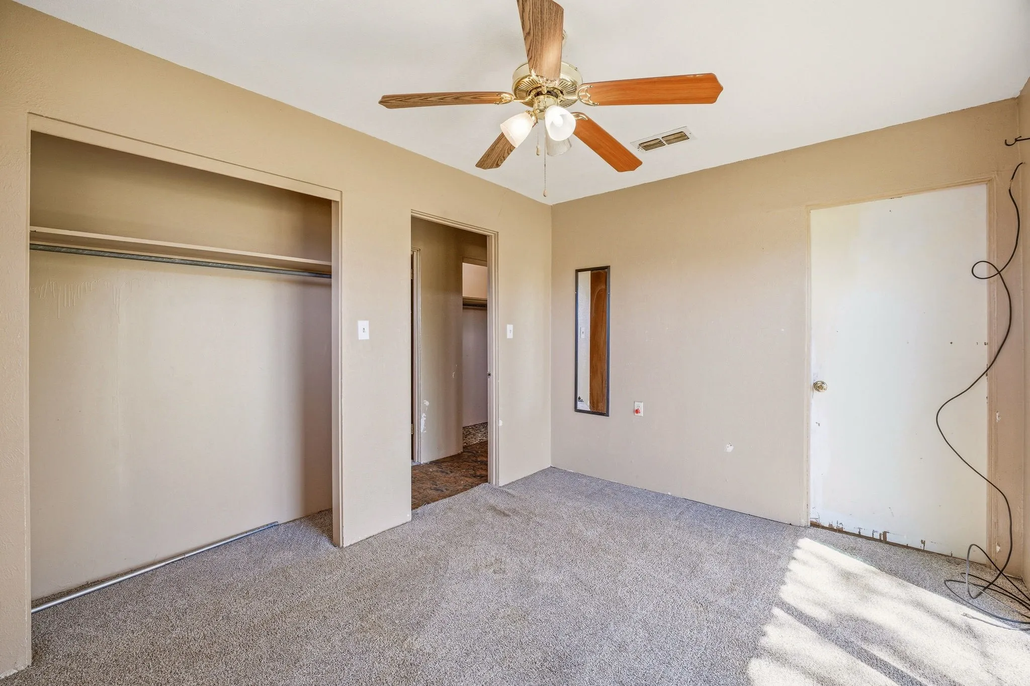 Unfurnished bedroom featuring carpet, a closet, and ceiling fan