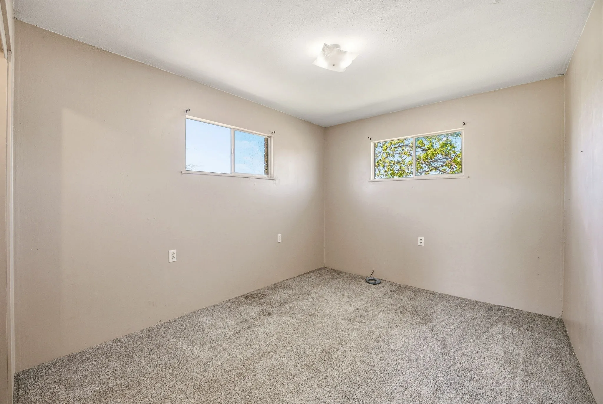 Spare room featuring light carpet