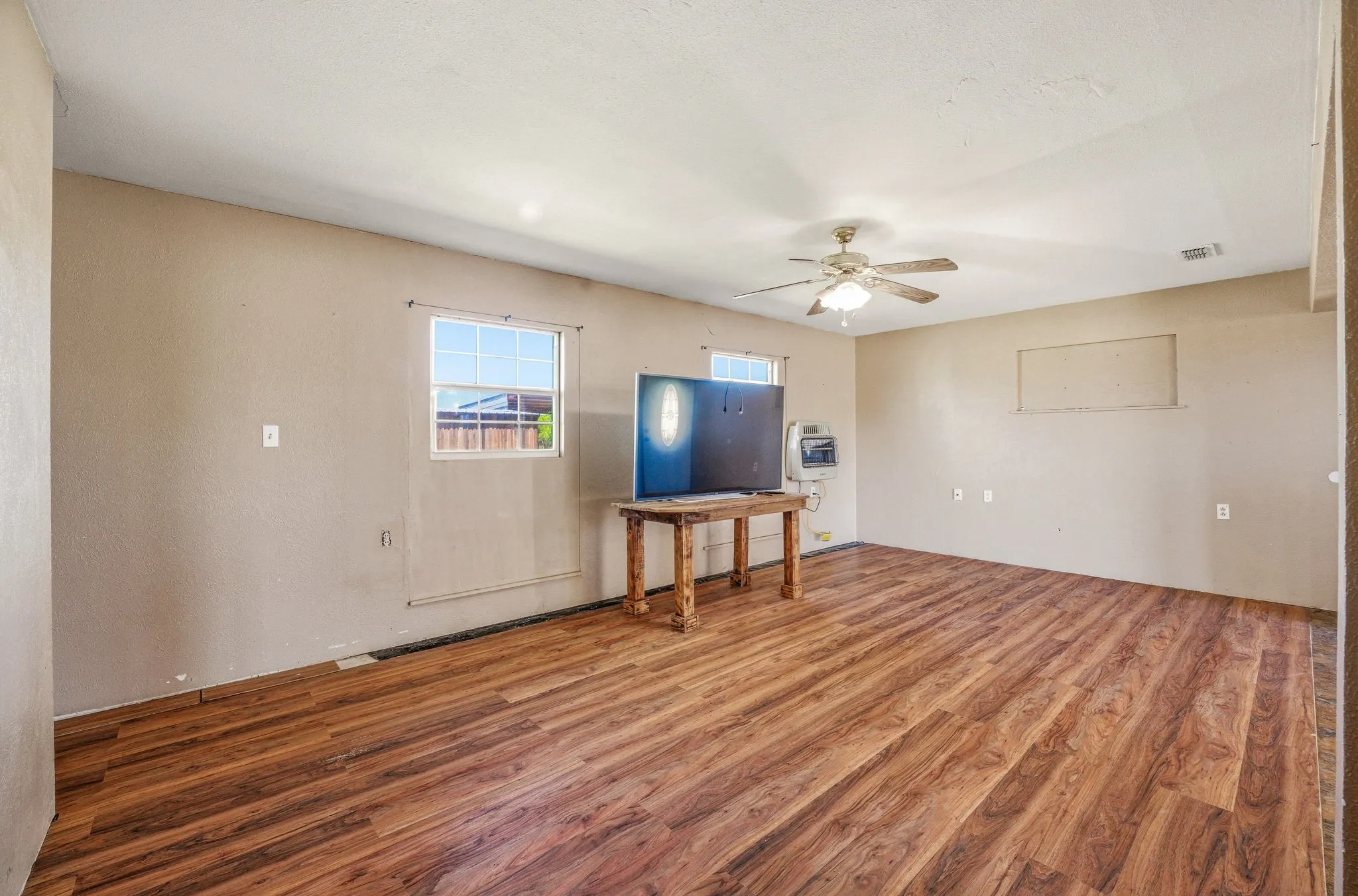 Living area with wood finished floors and a ceiling fan