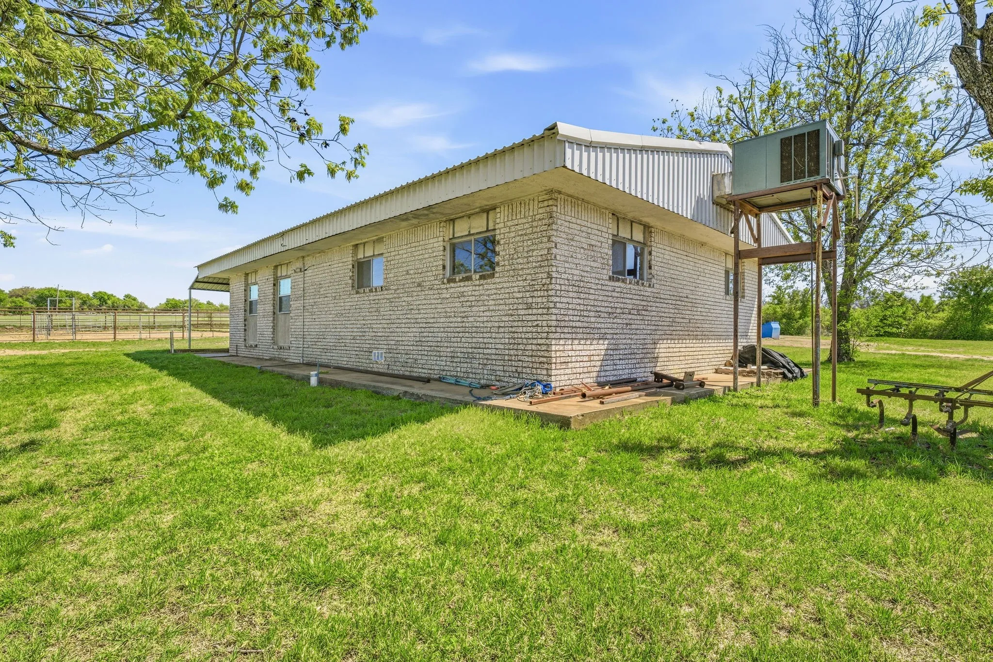 View of home's exterior featuring a balcony and brick siding