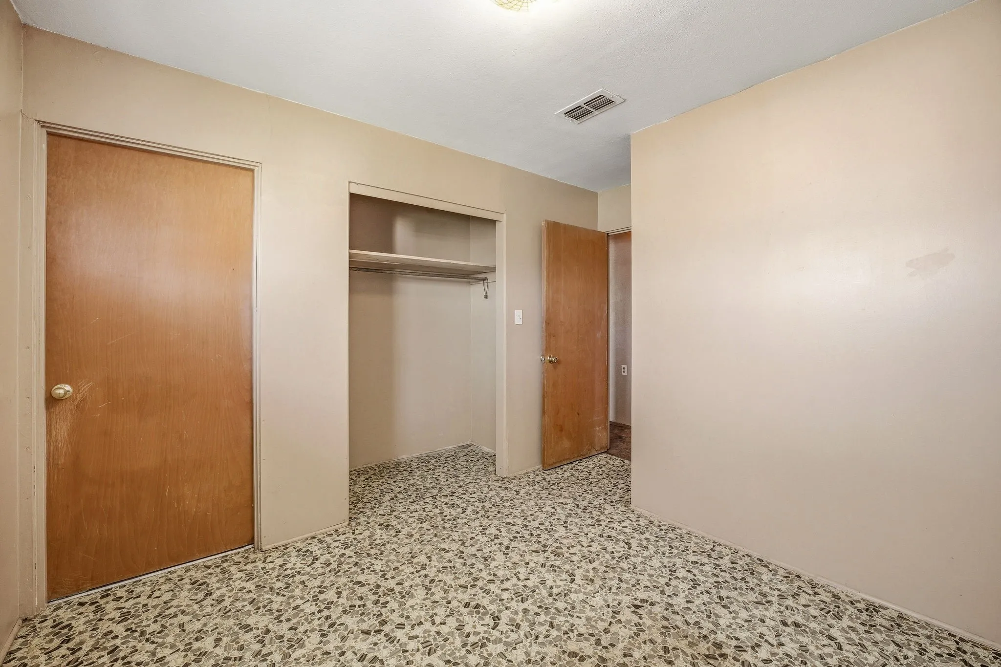 Unfurnished bedroom featuring a closet and light flooring