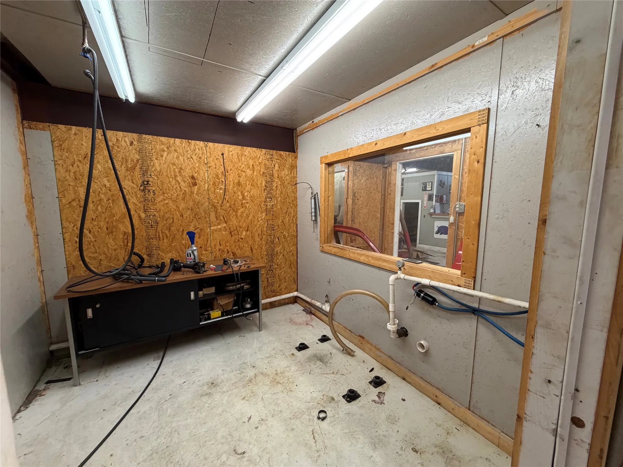 Miscellaneous room featuring unfinished concrete floors