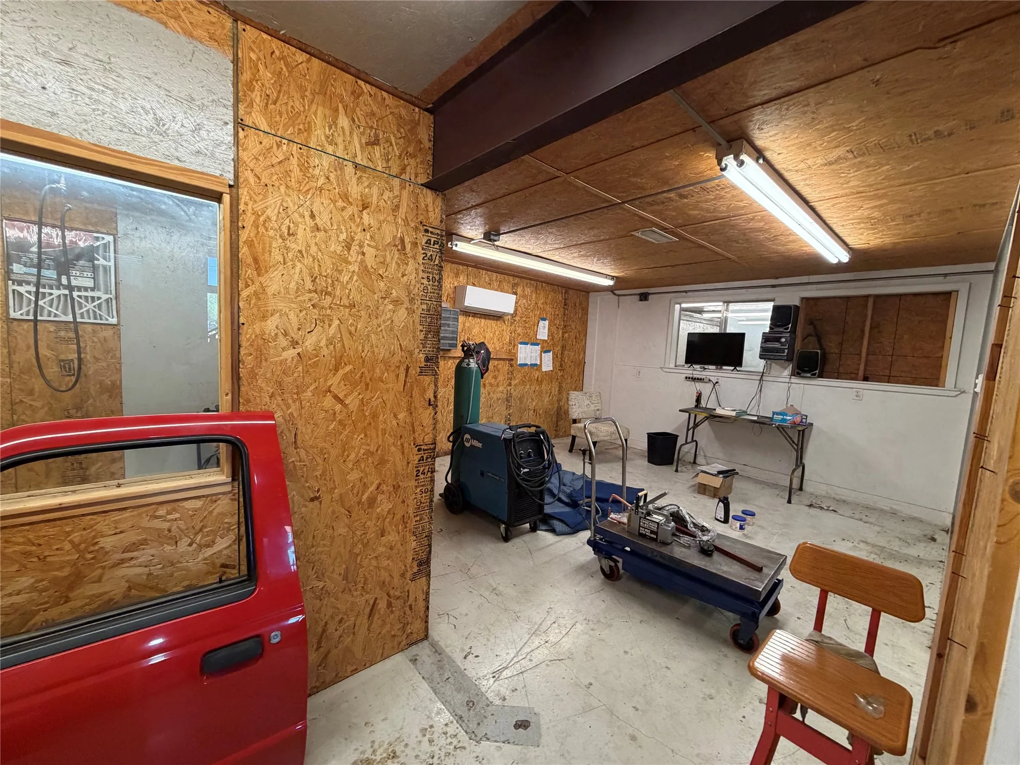 Basement featuring a wall unit AC