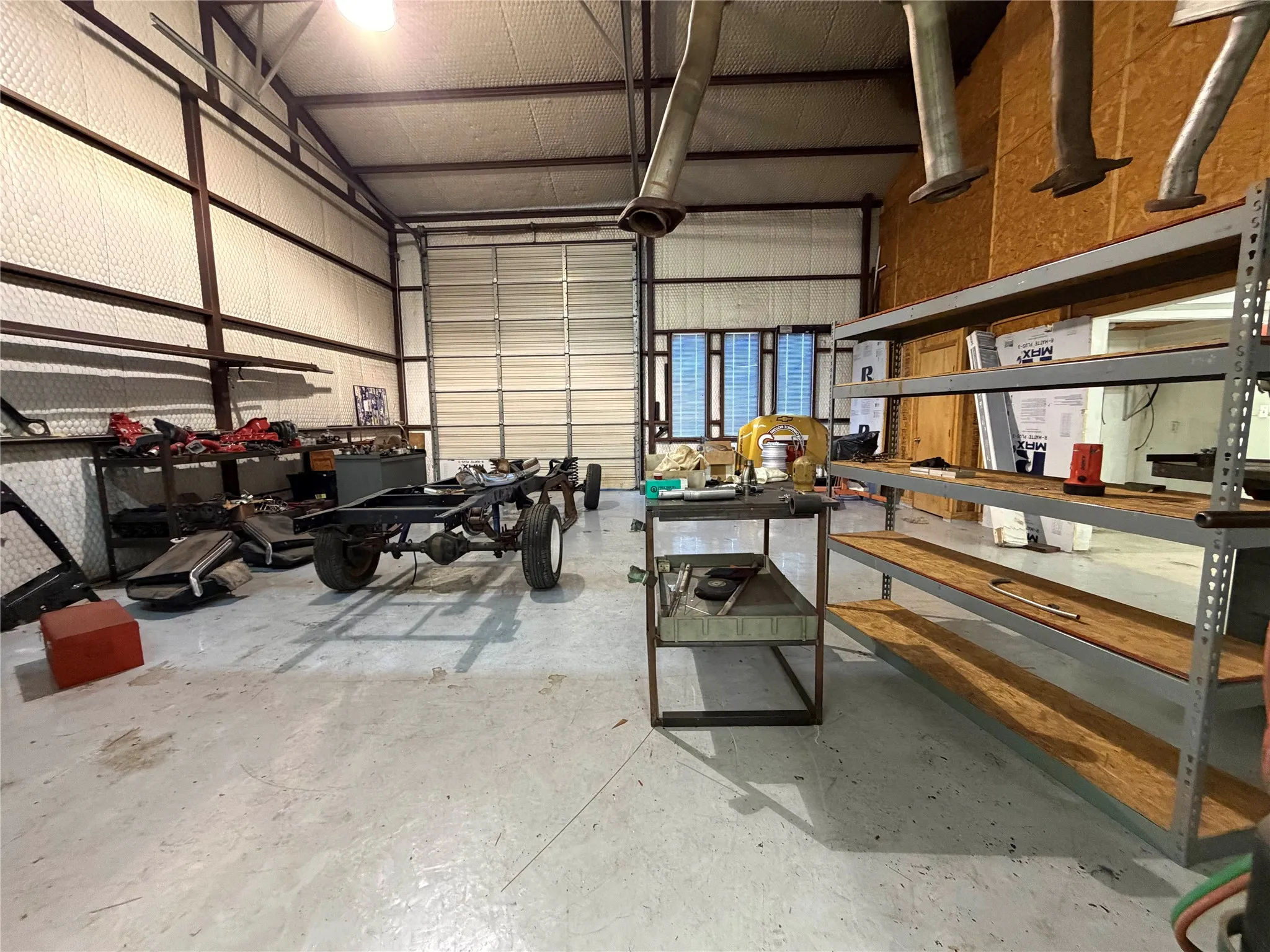Garage with metal wall and a workshop area