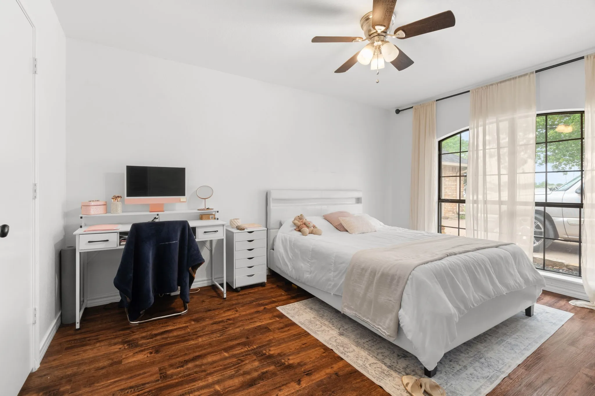 Bedroom with dark wood-style flooring, a desk, and ceiling fan