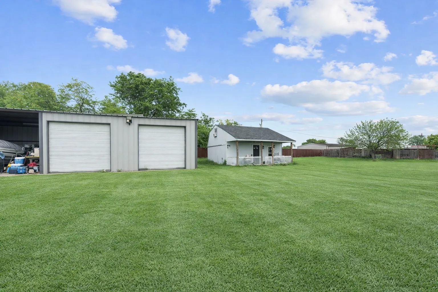 View of yard with an outdoor structure and a detached garage