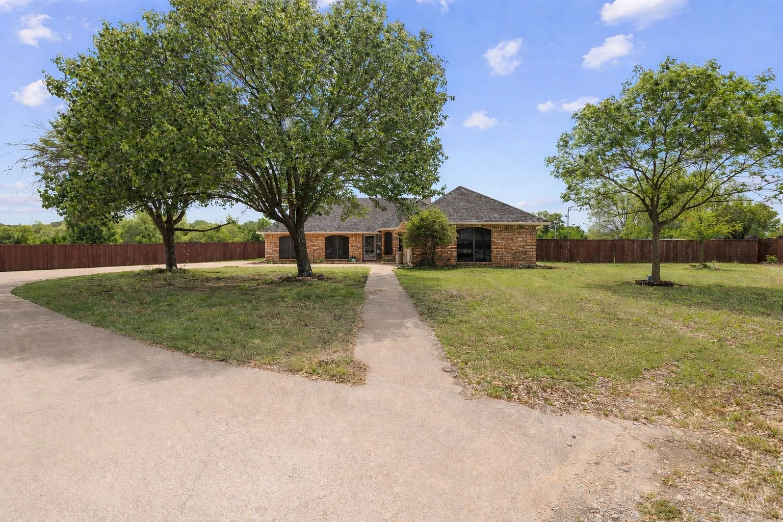 Single story home featuring brick siding