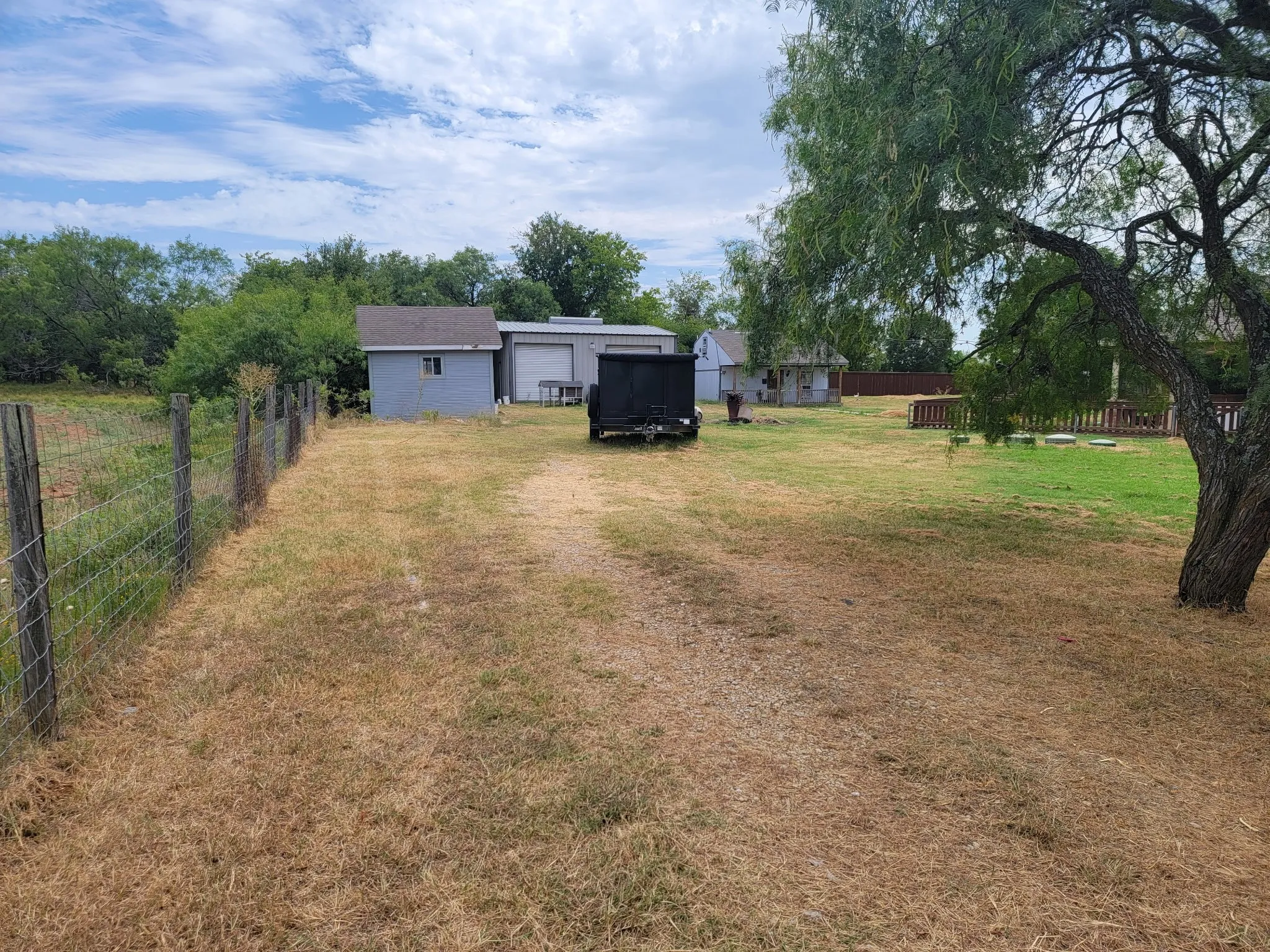 View of yard with a garage and driveway