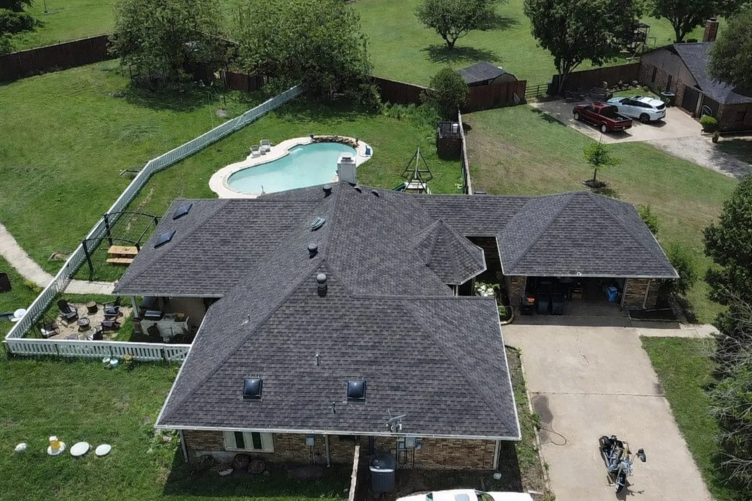 Aerial view of property and surrounding area featuring a pool