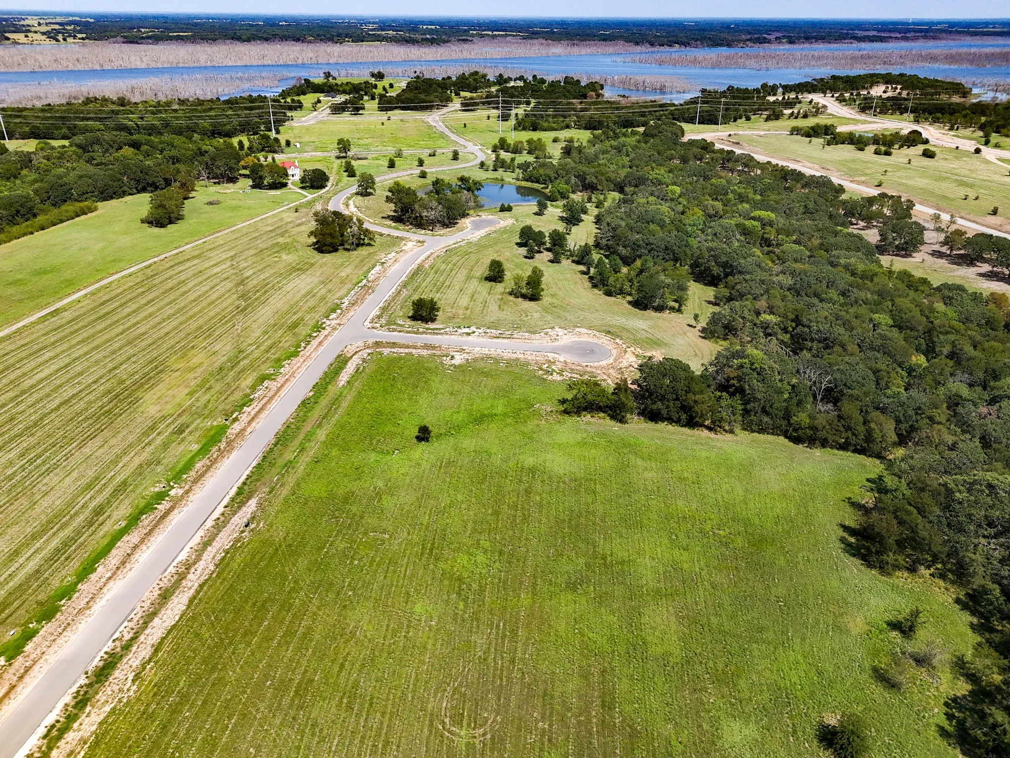 Aerial view of property and surrounding area featuring a large body of water