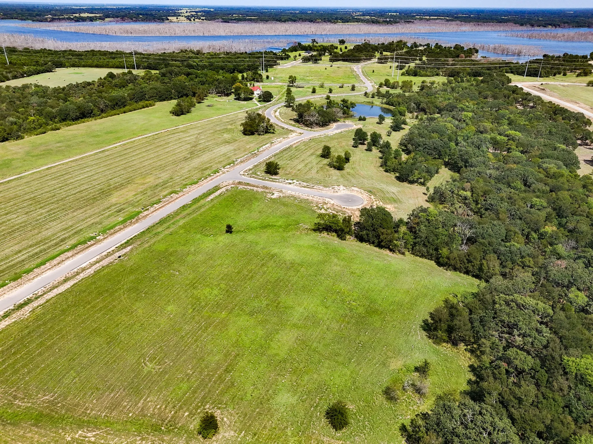 Aerial view of property's location with a large body of water