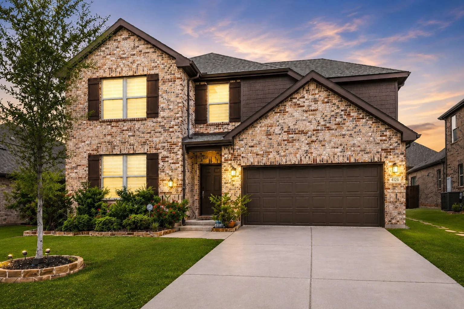 Two-story brick exterior with dark brown siding accents