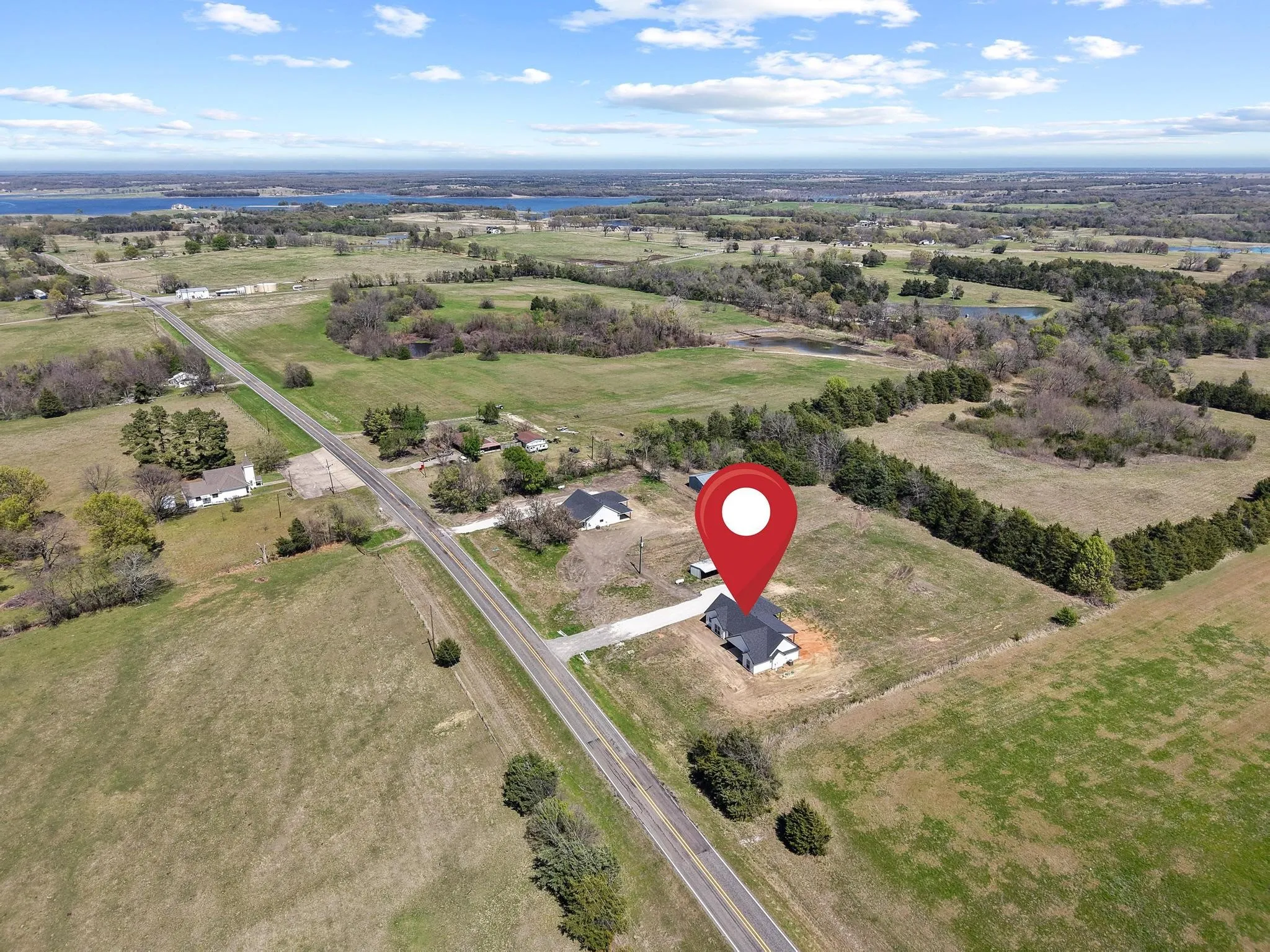 The property is situated in a rural setting with expansive green fields