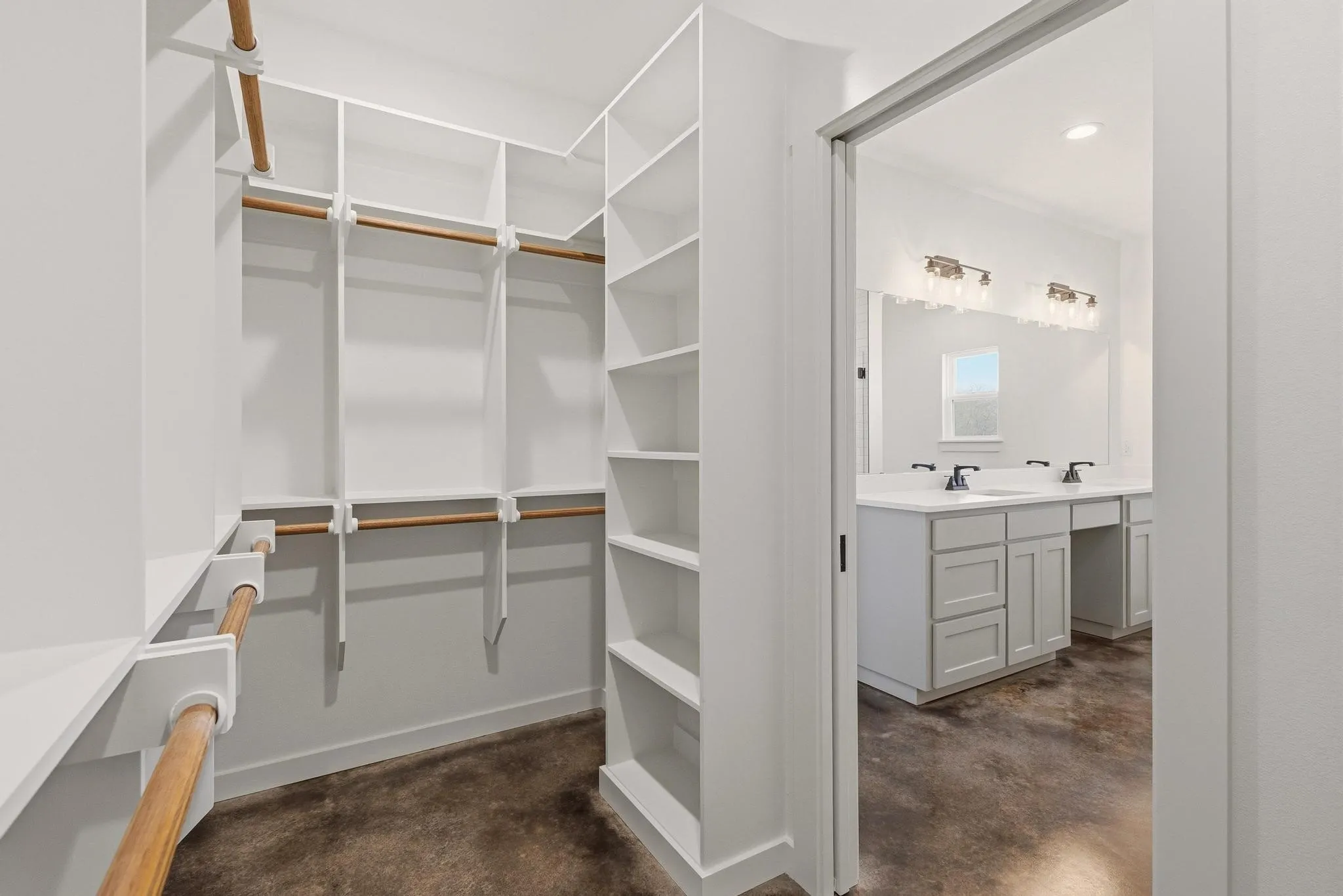The property features a spacious walk-in closet with extensive built-in shelving and hanging rods