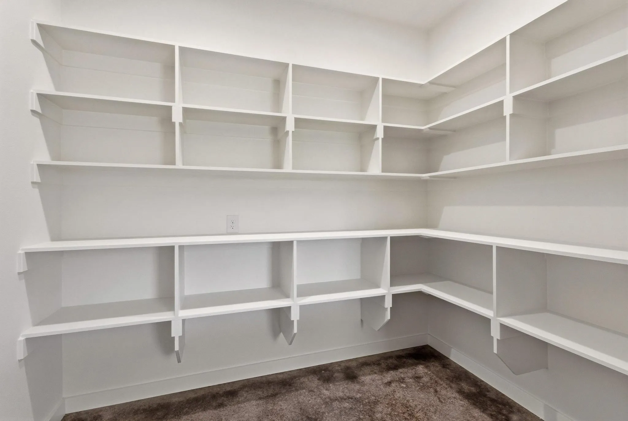 The property features an expansive corner pantry with extensive built-in shelving, providing ample storage solutions