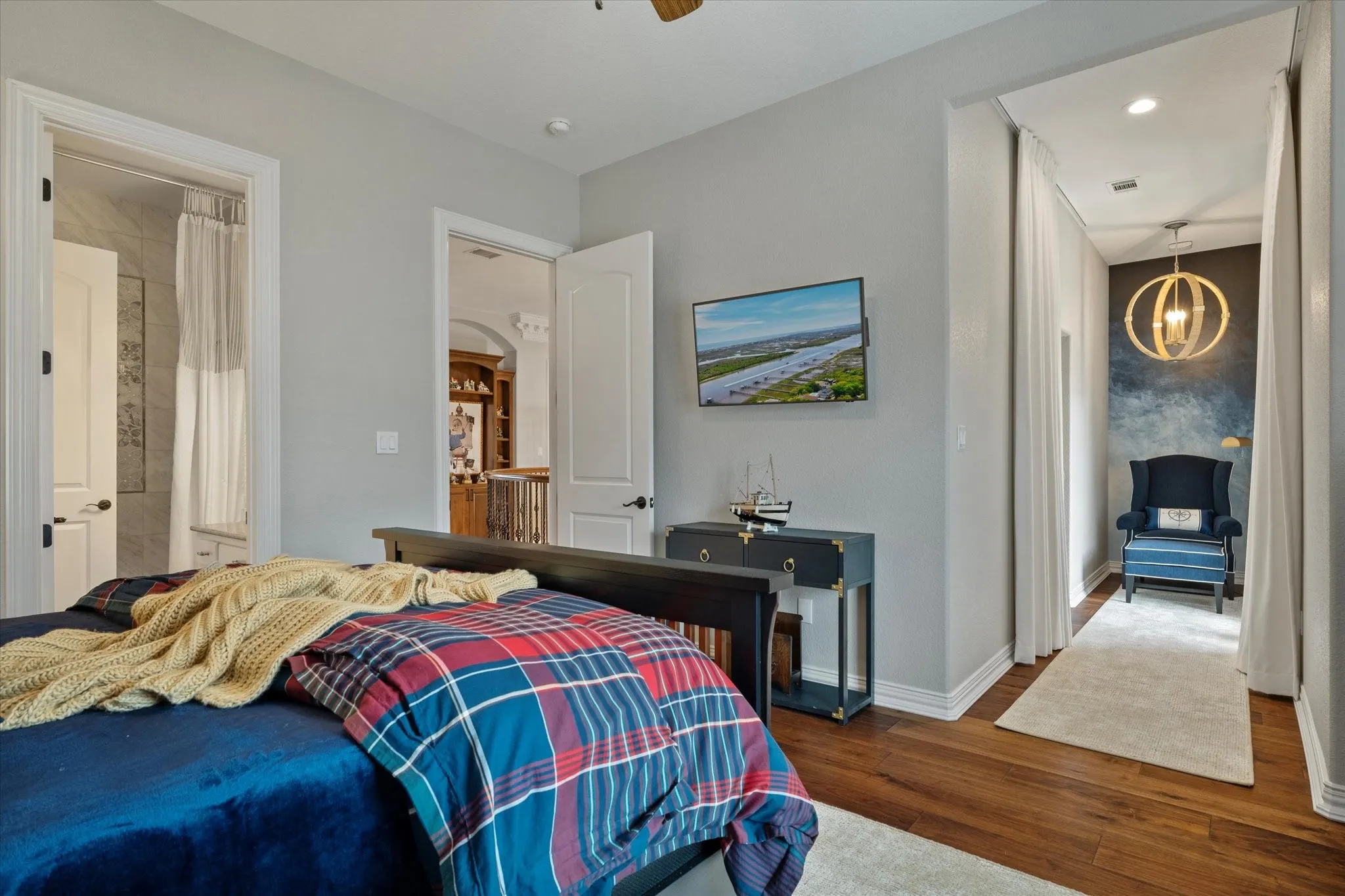 This room features hardwood floors and light gray walls