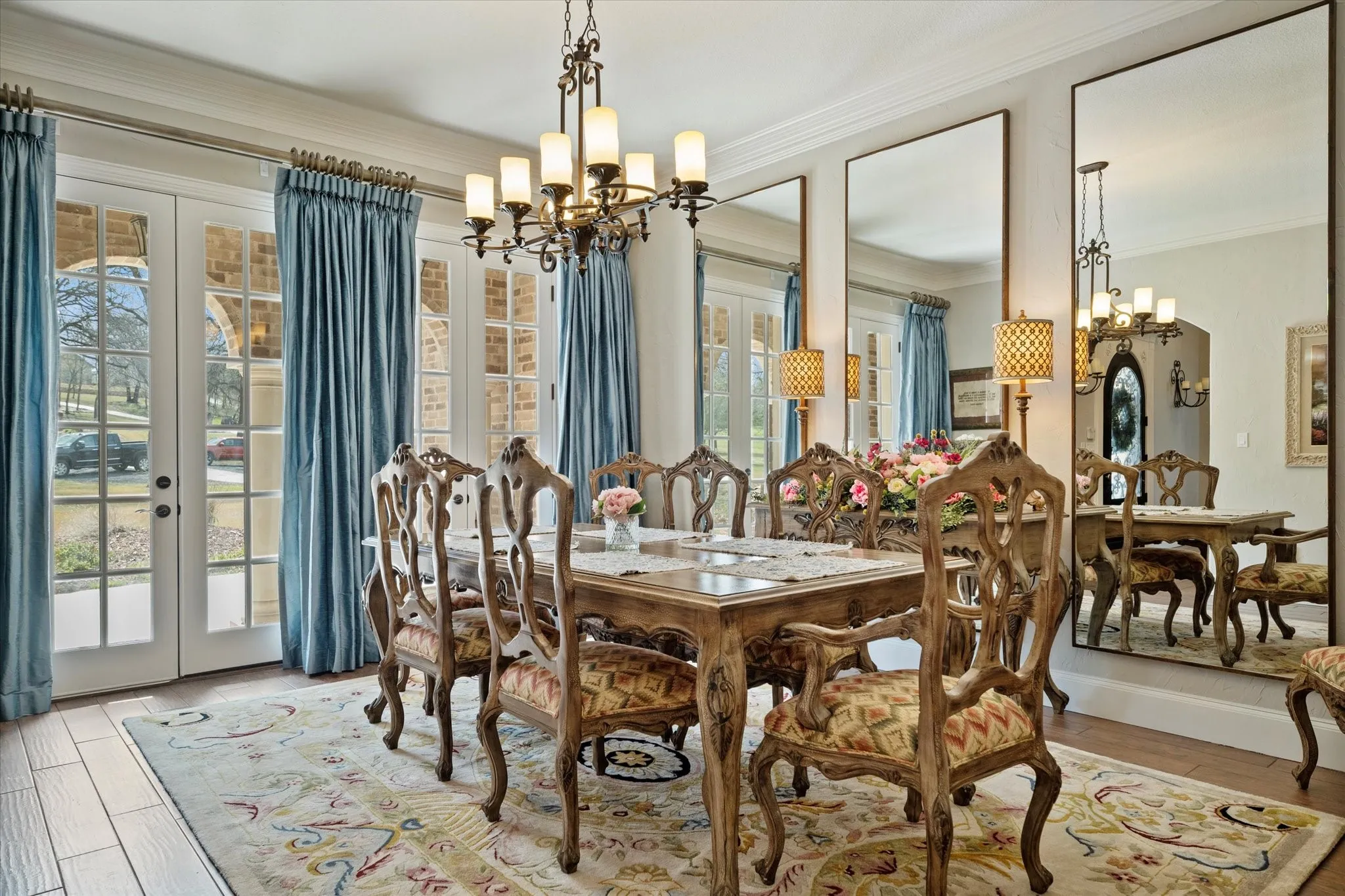 This dining area features light-colored flooring and a decorative area rug