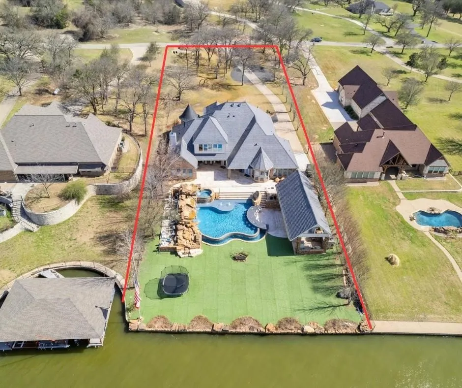 This property features a grand residence with a multi-gabled roofline and an expansive outdoor space