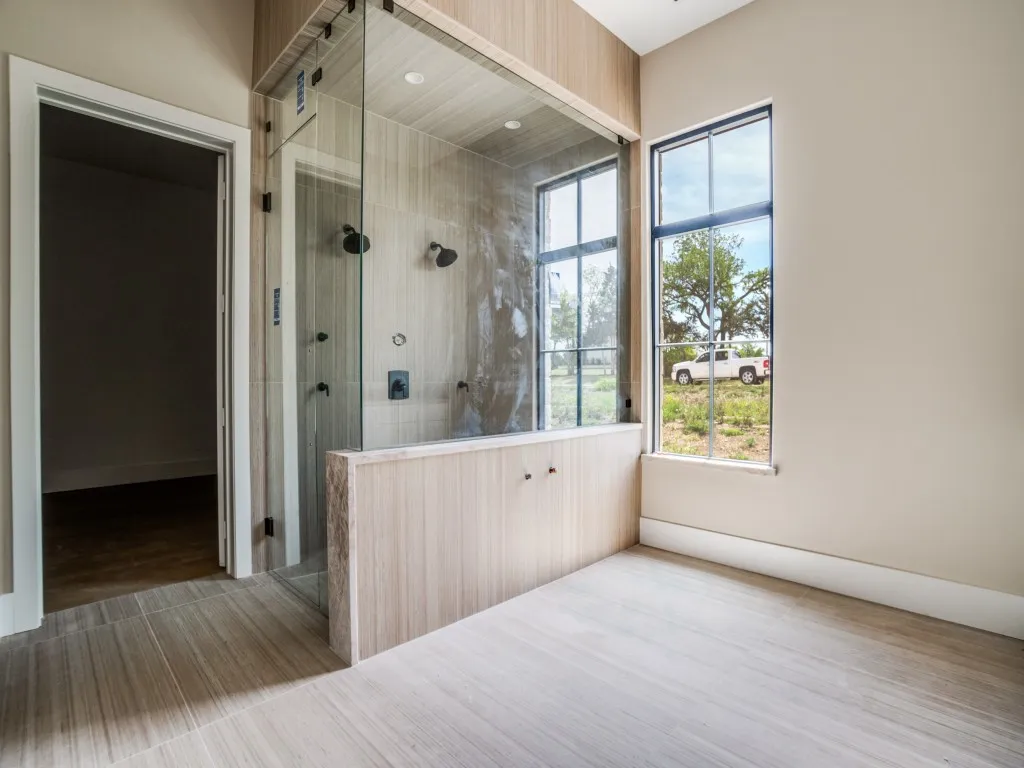 Primary bathroom features a steam shower with dual shower heads, space for a freestanding tub, dual vanities, and a large walk in closet that is ready for your designer.