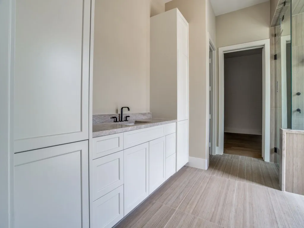 Ample cabinets in the primary bathroom allow for all of your storage needs.