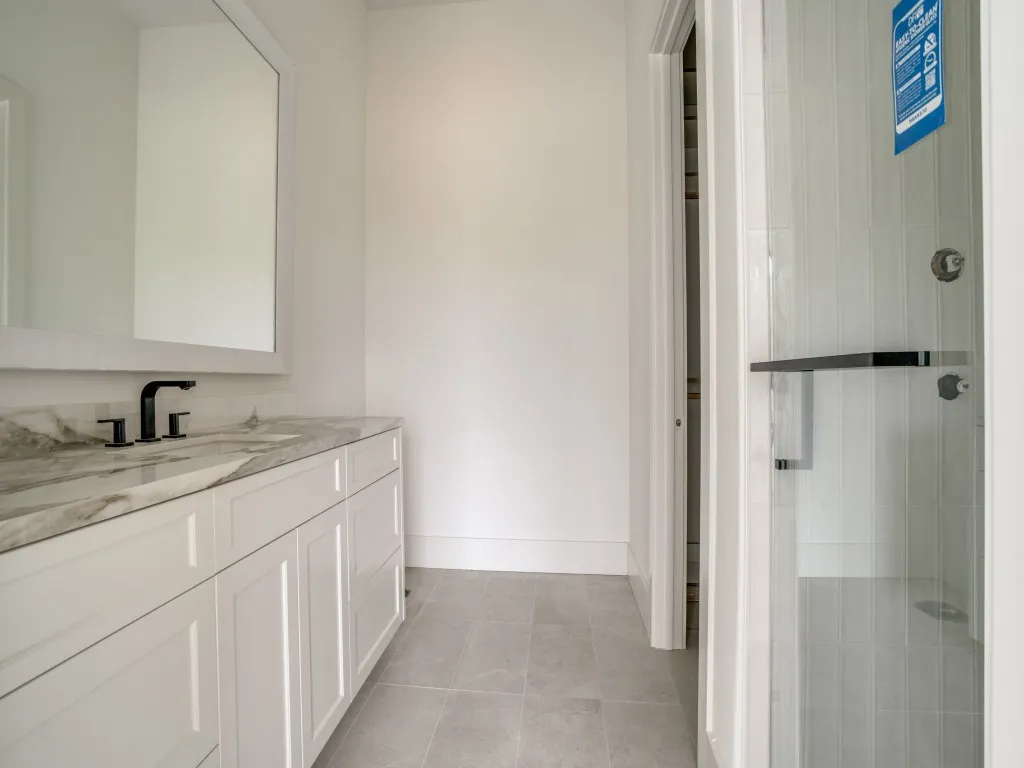 Ensuite bath for the children's rooms feature walk in showers and custom closets.
