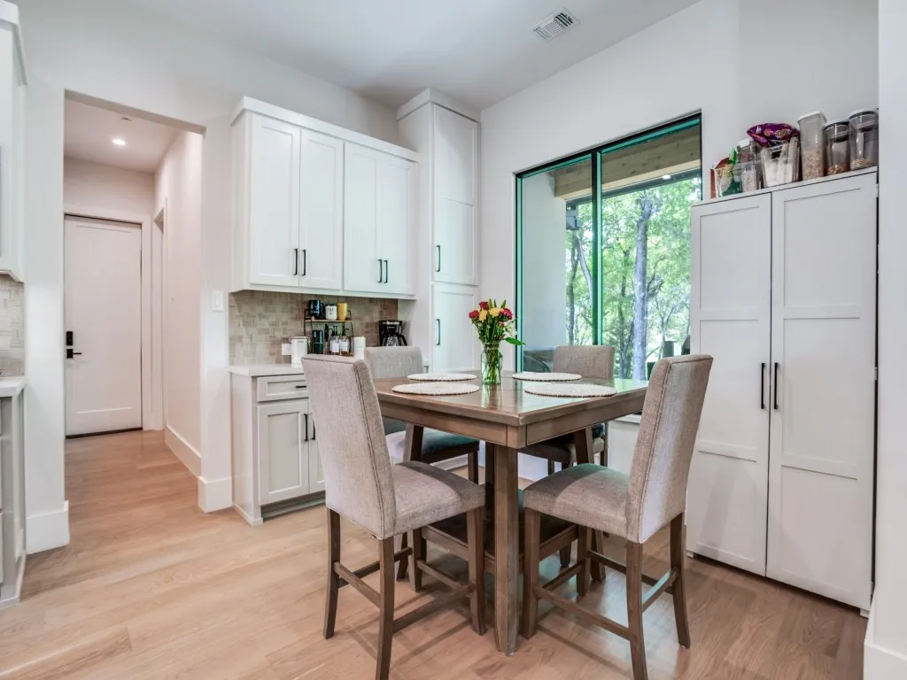 Guest house dining room with built ins and view of the trees and private late,