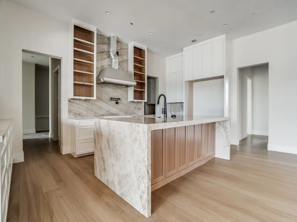 Chef's kitchen with statement island, custom cabinetry, pot filler, additional workspace, attached prep kitchen, and separate walk in pantry. Custom cabinetry built for high end appliances.