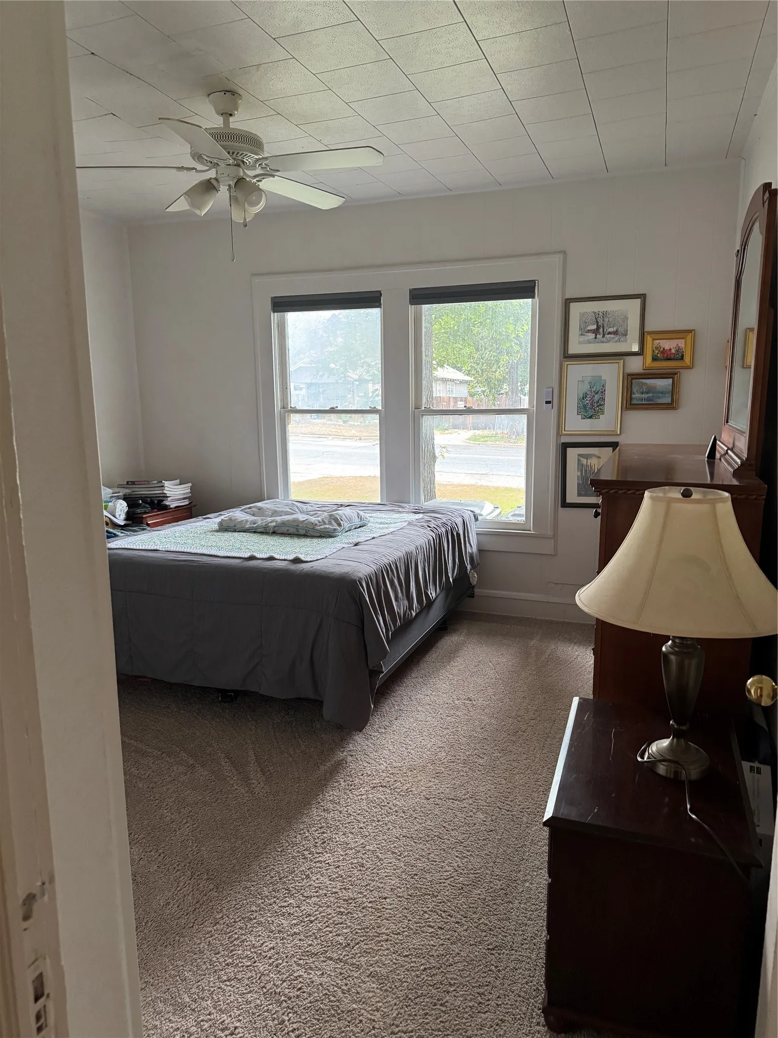 Bedroom featuring dark colored carpet and a ceiling fan