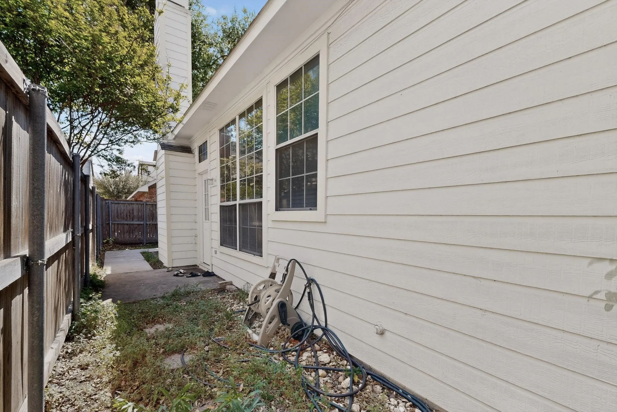 View of side of property featuring a fenced backyard