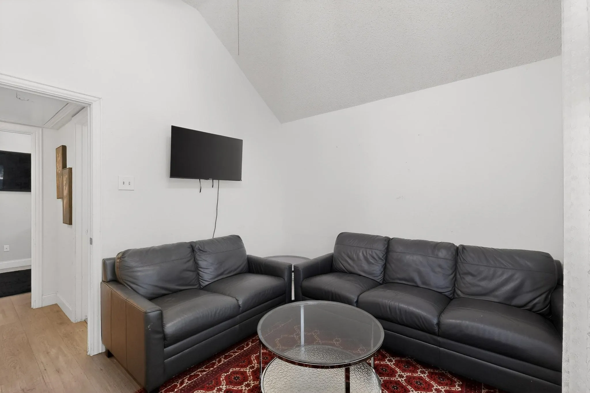 Living room with vaulted ceiling and wood finished floors