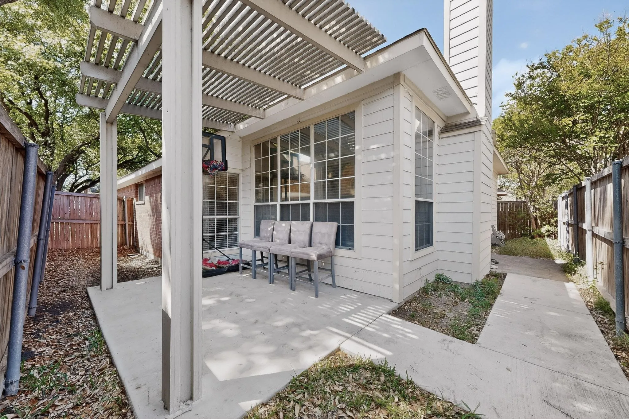 Fenced backyard featuring a pergola and a patio
