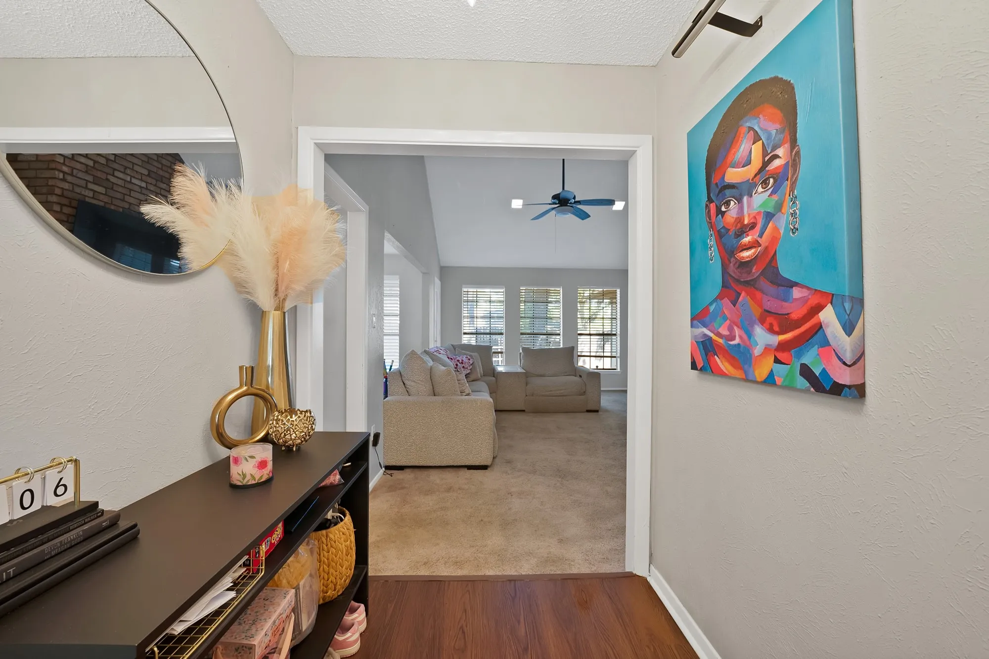 Hall with wood finished floors, a textured ceiling, and carpet