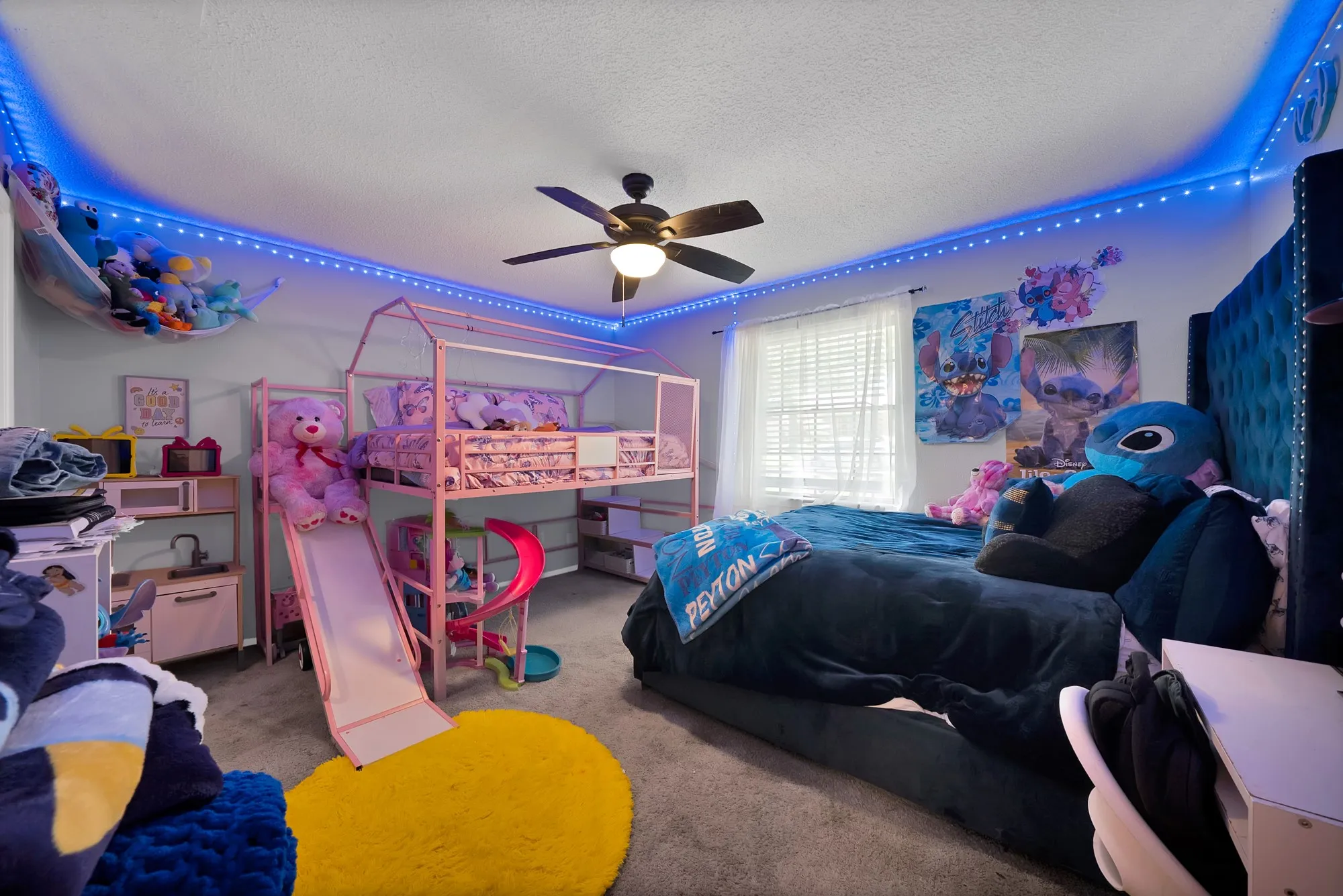 Bedroom featuring a textured ceiling, light carpet, and ceiling fan